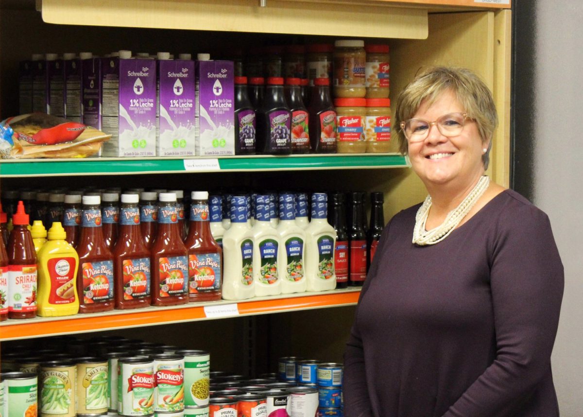 Coordinator of Accessibility Services Vicky Abel show variety of items available at a Fall 2023 market. 