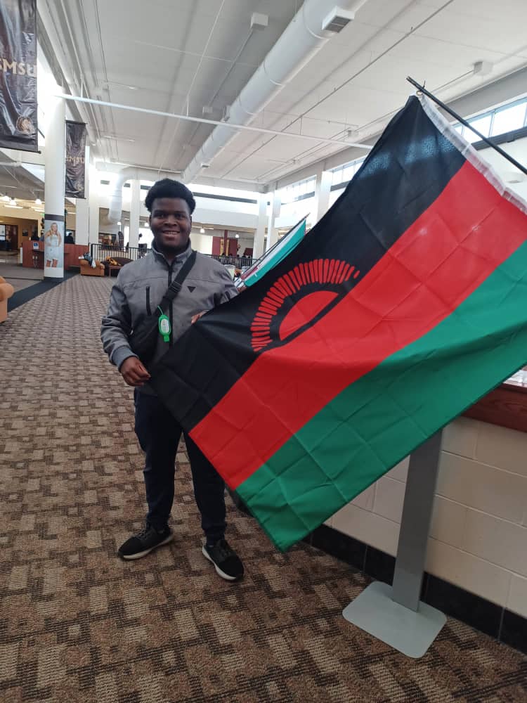 Bryan Kachingwe Posing with the Malawi Flag 