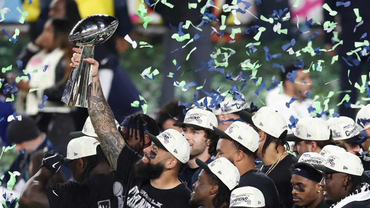 Seattle Seahawks players celebrate with trophy after win.
Photo by Patrick T. Fallon / AFP via Getty Images